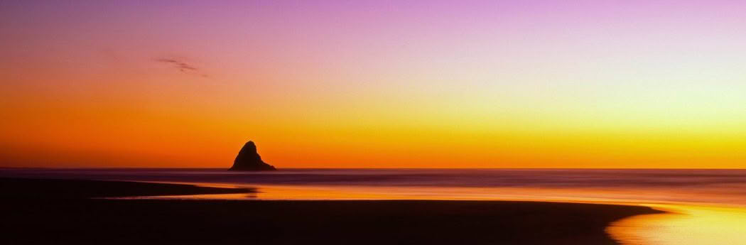 New Zealand Landscape Photography Alone Karekare Beach at sunset with Paratahi Island, Karekare Beach, New Zealand