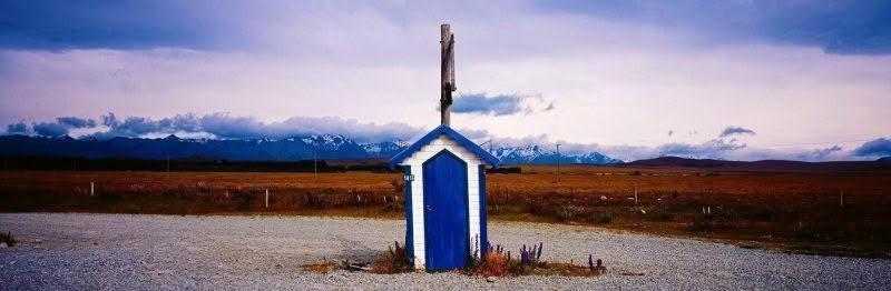 Irishman Creek Station Hut, Tekapo New Zealand. Blue hut at entrance of Irishman Creek Station with mountains in background