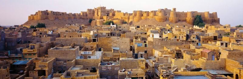 Jaisalmer, Rajasthan, India. Dawn light's up Jaisalmer showing the rooftops leading to the fortress.