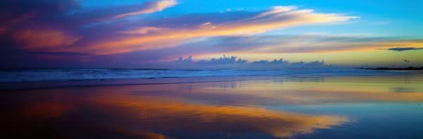 New Zealand Landscape Photography Reflected Glory Ahipara Beach in Northland New Zealand at sunrise with the clouds reflecting in the wet sand