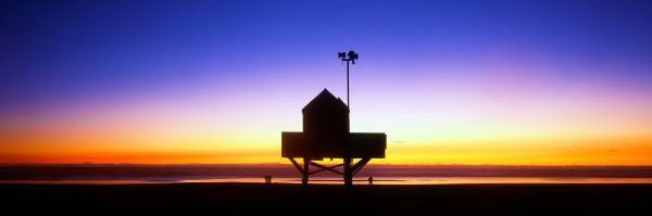 New Zealand Landscape Photography Standing Guard Bethells Beach lifeguard tower at sunset