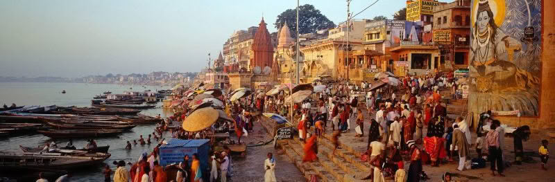 Varanasi, India. The River Ganges and shoreline / steps at Varanasi with pilgrims bathing