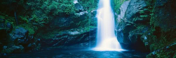 Large waterfall and rocky scene at Waimea Falls, Tasman District, New Zealand.