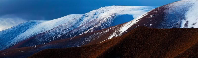 Whisper, Lindis Pass New Zealand. Snow on the peaks of the Lindis Pass
