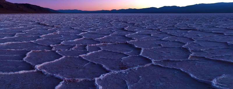 Badwater Basin. Dramatic patterns in foreground at sunset at salt plains of Badwater Basin