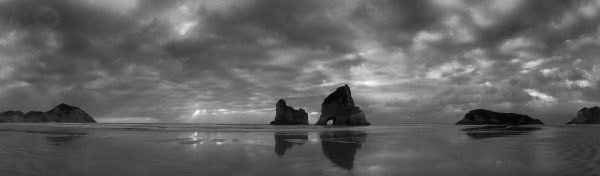 New Zealand Landscape Photography Wharariki Beach. Monochrome of beach and islands at Wharariki Beach with cloud covering.