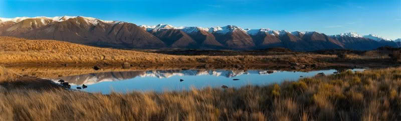 Ohau Dawn. Ben Ohau range reflected in small pond on clear winters morning.