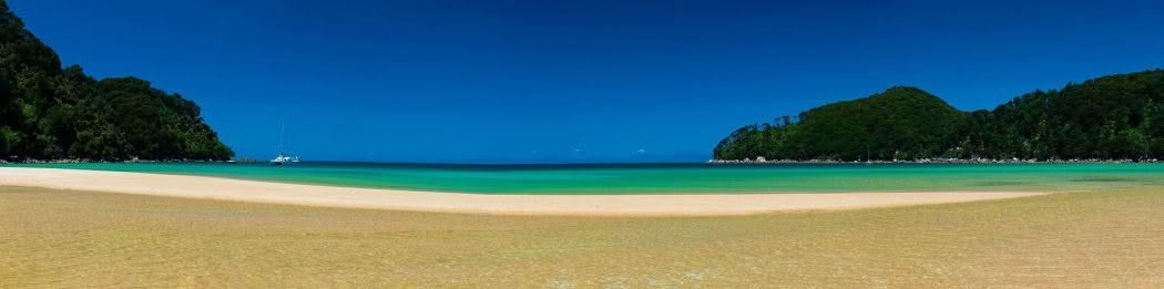 New Zealand Landscape Photography Bark Bay. Beach, clean water and blue sky in Abel Tasman National Park