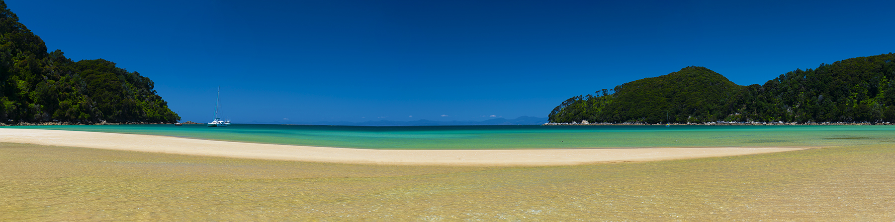 New Zealand Landscape Photography Bark Bay. Beach, clean water and blue sky in Abel Tasman National Park