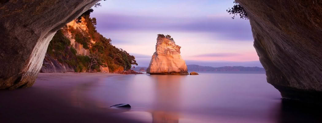 New Zealand Landscape Photography Cathedral Cove, Cathedral Cove at dawn with soft pastel colours.