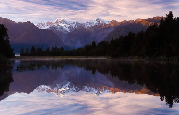 New Zealand Landscape Photography Lake Matheson. Mountains reflected in lake at dawn.