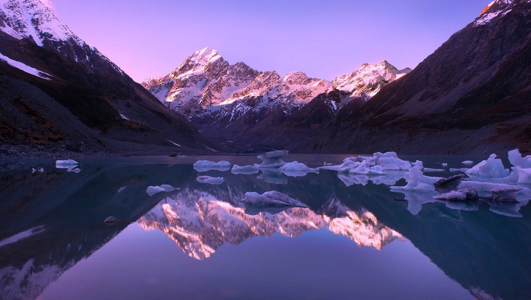 Aoraki Mount Cook reflected in Hooker Lake with icebergs at dusk