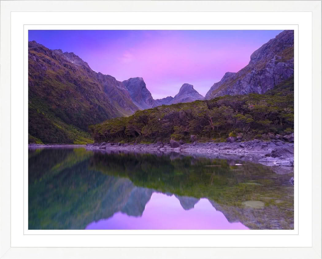 New Zealand Landscape Photography Lake Mackenzie on the Routeburn Track. Dawn pink light of mountains reflected in lake.