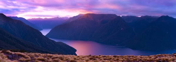 New Zealand Landscape Photography. Lake Te Anau at dusk with pink sky and Murchison Mountains