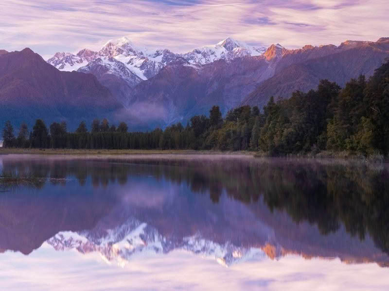 Lake Matheson on the West Coast of the South Island. Mt Cook reflected in the dawn light