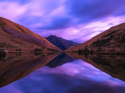 Lake Kirkpatrick reflecting the surrounding mountains at dawn, Otago, New Zealand