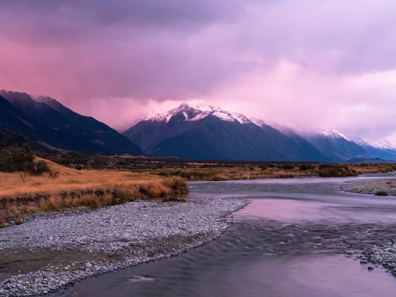 Aoraki / Mount Cook National Park seen from the Tasman Valley at dusk with river reflections and mountain light