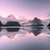 Milford Sound at dawn with mountain peaks and reflections in Fiordland, New Zealand