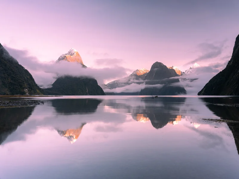Milford Sound at dawn with mountain peaks and reflections in Fiordland, New Zealand